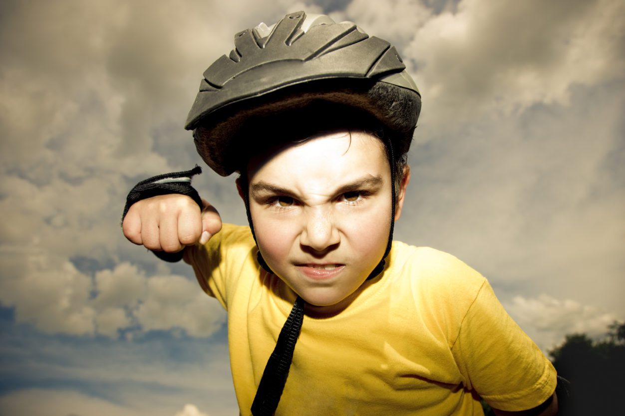 Boy with helmet and fist up