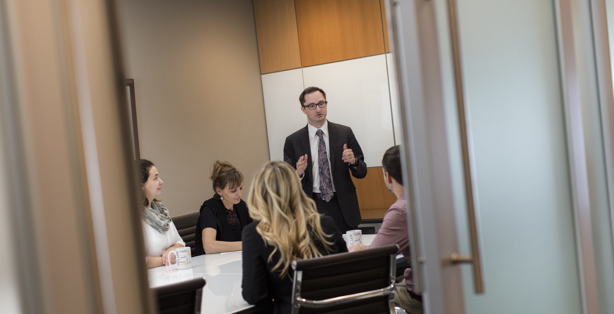Andrew Prior Speaking to seated people in boardroom highlighting arbitration and mediation