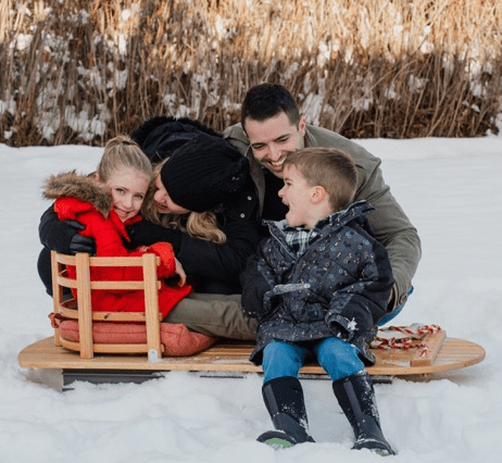 Family in Winter with Sled and jackets and snow boots