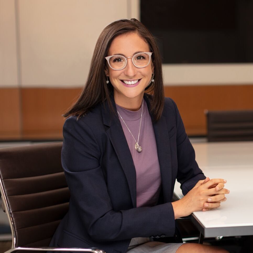 Remy Ventura, associate litigator, in office with chairs and television