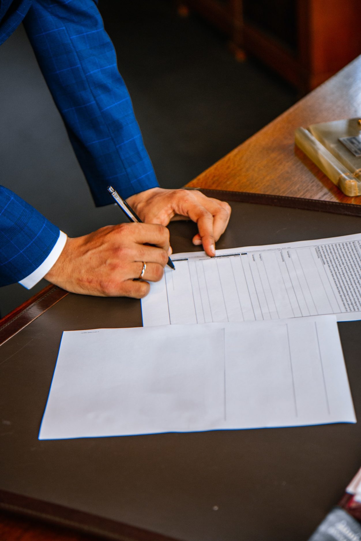 A businessman signing a document.